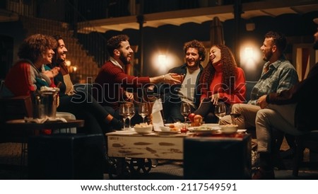 Big Dinner Garden Party Celebration with Friends on a Warm Summer Evening. Beautiful People Enjoy Life on a Terrace, Chat, Relax on Weekend, Have Fun, Drink Wine, Give Toasts and Eat Homemade Food. Royalty-Free Stock Photo #2117549591