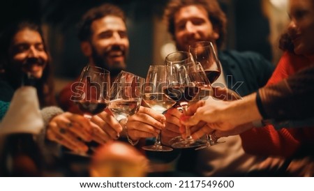 Big Dinner Garden Party Celebration with Friends on a Warm Summer Evening. Beautiful People Enjoy Life on a Terrace, Drink Wine, Cheers, Relax on Weekend, Give Toasts and Eat Homemade Food. Royalty-Free Stock Photo #2117549600