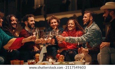 Big Dinner Garden Party Celebration with Friends on a Warm Summer Evening. Beautiful People Enjoy Life on a Terrace, Talk, Relax on Weekend, Have Fun, Drink Wine, Give Toasts and Eat Homemade Food. Royalty-Free Stock Photo #2117549603