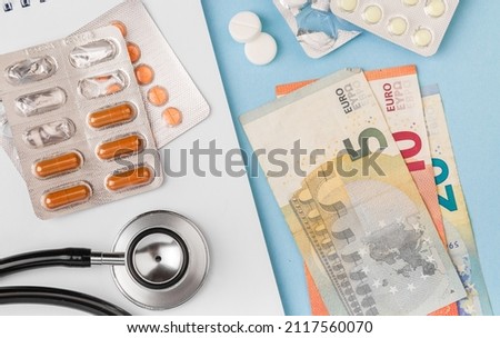 Price of medicine. Medical expenses. Cost of health care with EURO bank notes, stethoscope and medicaments. EURO small bills cash money. Cost of medicinal products and treatment concept. Copy space