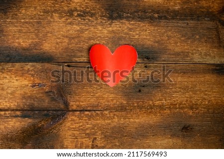 Red paper heart on a wooden background. valentine's day concept. Declaration of love.