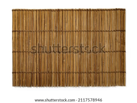 Brown bamboo table mat isolated on a white background. Old wooden luncheon mat for place your food. Textured surface of empty dining placemat. Design element for asian style set table appointments. 