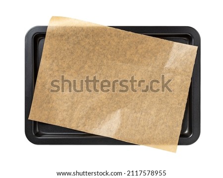 Baking sheet with brown parchment paper isolated on a white background. Empty oven tray for baking and roasting. Rectangular baking pan for food design. Nonstick kitchen utensils. Top view. Royalty-Free Stock Photo #2117578955