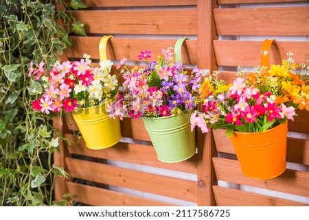 Hanging Flower Pots with fence Royalty-Free Stock Photo #2117586725