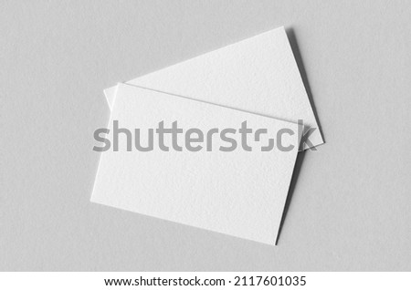 Textured business card mockup on a grey background. 85x55 mm.