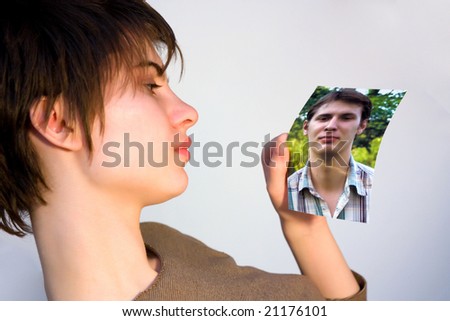 young woman looking at a picture of a man