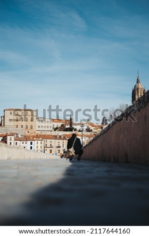 
Tourist taking a photo on a roman bridg