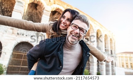 Married couple of tourists walking on city street visiting Italy - Senior man and woman enjoying weekend vacation - Happy lifestyle concept Royalty-Free Stock Photo #2117654573
