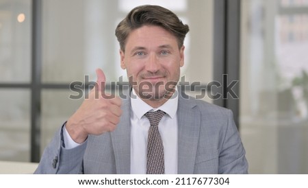 Portrait of Middle Aged Man showing Thumbs Up Sign
