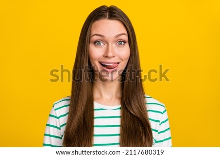 Photo of pretty childish lady dressed striped shirt smiling stick out isolated yellow color background