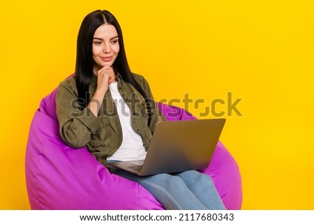 Photo of sweet young lady look laptop think wear shirt jeans isolated on yellow background