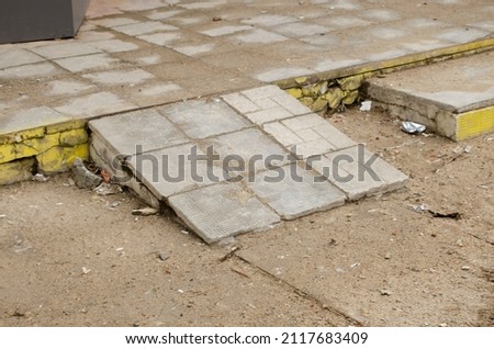 Broken concrete ramp in the sand and mud