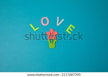 Valentine's day concept with letters love and wooden heart. Decor in shape of word LOVE. white letters. Valentine concept. Color of the year 2022. Very peri tint. Selective focus.