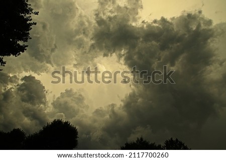 Dark grey sky with Stratocumulus and Altocumulus clouds