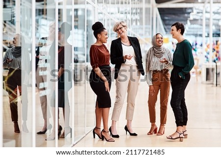 Female business people or Friends - Diverse Group of Females Only in a modern Office discussing and laughing. Multi ethnic natural group of business people with age diversity in a modern company Royalty-Free Stock Photo #2117721485
