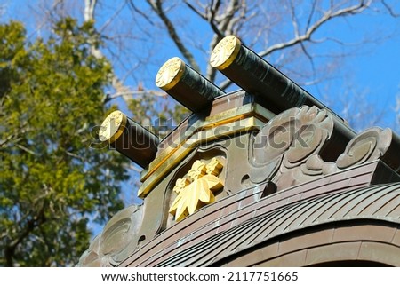 Roof design image of the Japanese Kamakura period wooden shrine architecture. With trees an sunny sky background.