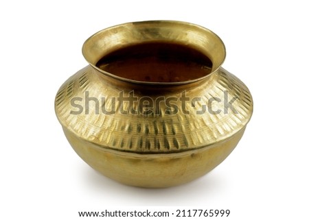 Indian kitchen utensil brass metal pot on white background   Royalty-Free Stock Photo #2117765999