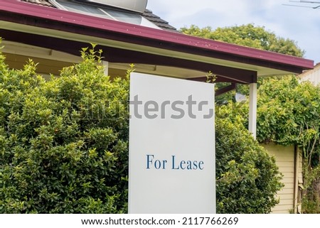 For lease sign on a white display outside of a resedential building house in Australia. Investment property real estate concept