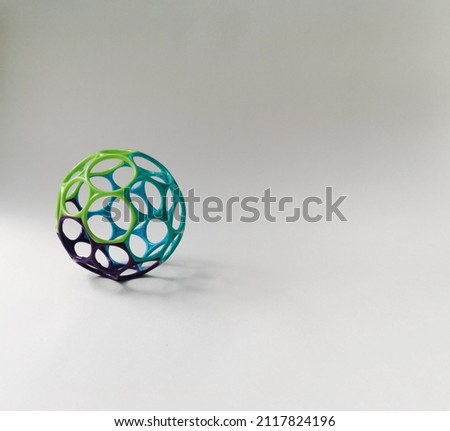 A plastic ball with hexagonal holes.