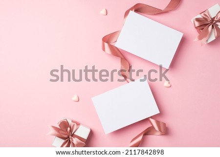 Top view photo of valentine's day decorations curly silk ribbon hearts two small gift boxes with bows and two letters on isolated pastel pink background with empty space Royalty-Free Stock Photo #2117842898