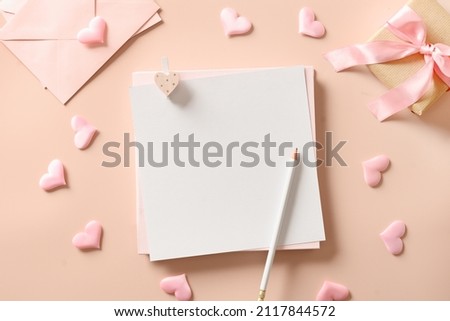 Valentine's day blank for letter with empty blank and pink hearts, gift on pink background. View from above. Space for text. Minimal flat lay. Greeting card
