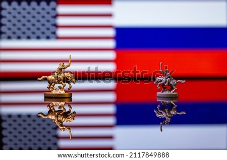 Conceptual image of war between United States and Russia using toy soldiers and national flags on a reflective background