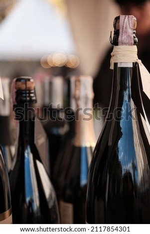 A closeup shot of bottles display at exhibitor stand at food and wine fair. Soft Focus Royalty-Free Stock Photo #2117854301