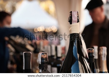 A closeup shot of bottles display at exhibitor stand at food and wine fair. Soft Focus Royalty-Free Stock Photo #2117854304