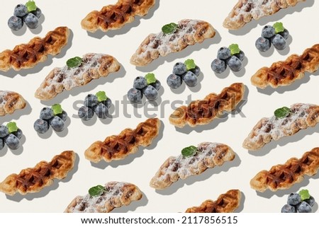 Pattern of freshly baked croffle mix of croissant and waffle on light background. View from above. Object repetition.