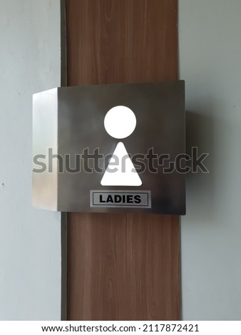 Signage for ladies restroom  with wood, steel and lighting design
