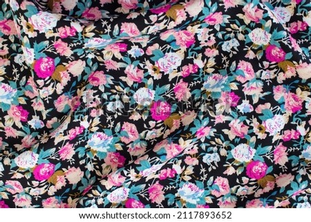 Floral print fabric. Dark background with pink peony bouquets.