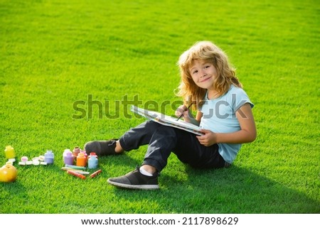 Kids painting in spring nature. Child boy drawing in summer park, painting art. Little artist painter draw pictures outdoor.