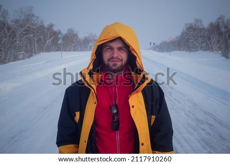 Guy on snowy road in winter in Kamchatka peninsula in Russia