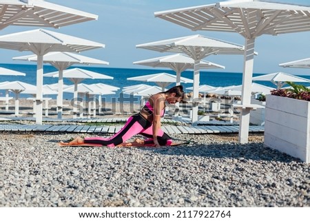 woman on exercise fitness yoga on the beach by the sea
