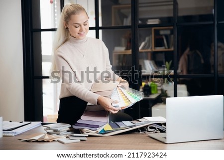 Happy Woman creative Interior designer working at office workplace with laptop.Online consultation with client through video call.