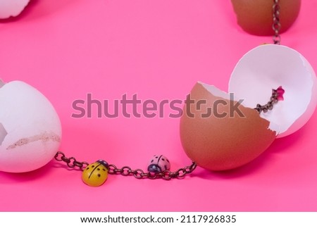 Creative Easter fashion concept -  egg crack shell necklace wish metal chain on bright pink background