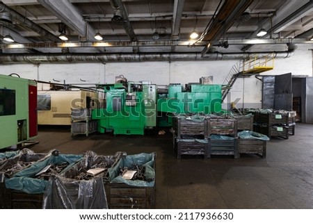 Photo of modern automatic automobile manufacturing workshop. Factory with steel constructions. Plant of car production. Industrial scenery background