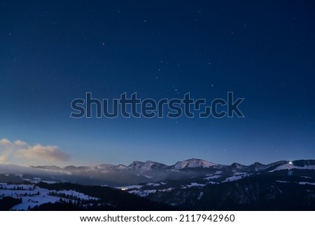 nightview in cold winter landscape with Orion star constellation at sky in the Allgaeu Alps near Oberstaufen, Bavaria, Germany
                Royalty-Free Stock Photo #2117942960