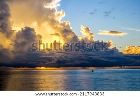 The sun is behind the clouds. Cloudy sky over water. Dark cloudy sky sunlight. Dark sky clouds landscape Royalty-Free Stock Photo #2117943833