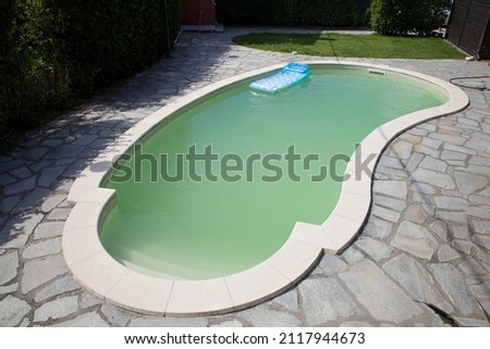 home swimming pool filled with water with green algae Royalty-Free Stock Photo #2117944673