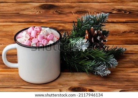 Cup of hot cocoa with marshmallows on wooden background, close up