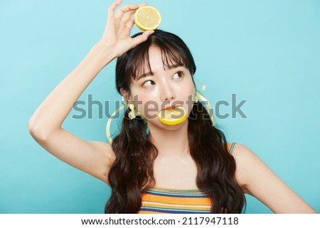 Fresh portrait of young Asian woman on blue background
