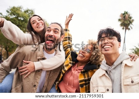 Happy friends from diverse cultures and races taking selfie outdoors. Cheerful people having fun