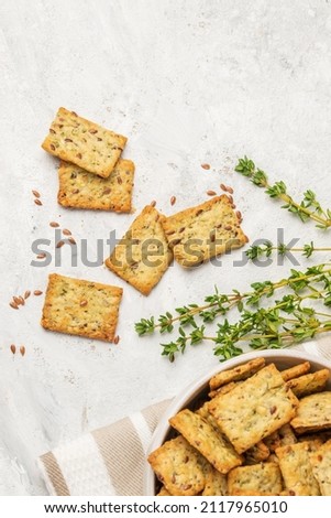 Homemade diet cookies with herbs, flaxseed and spices  on  light table. Herbal crunchy crackers with green thyme, top view with copy space Royalty-Free Stock Photo #2117965010