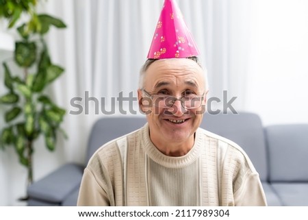 Horizontal image of attractive senior male with cone hat