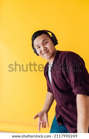 Asian man dancing to music song