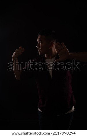 Asian man dancing to music song
