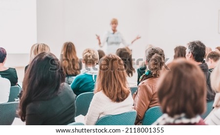Female speaker giving a talk at business meeting. Audience in conference hall. Business and entrepreneurship symposium. Royalty-Free Stock Photo #2118001355