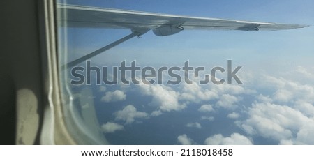 see the clouds behind the airplane window

￼


