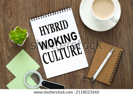 HYBRID WORKING CULTURE open notepad with text near different stationery and stickers. on a wooden background. business concept